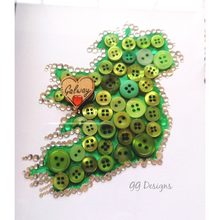 Load image into Gallery viewer, Handmade framed button and crystal map of Ireland. Send a little bit of Ireland to a loved one living abroad.   Beautifully presented in a 10x10&quot; white or black Irish made frame.  This is also a great gift for a new home, wedding or engagement!  The text and heart can be changed to suit your requirements. Please add this information into the custom message box.  A truly unique and special gift to let them know you&#39;re thinking of them. 
