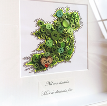 Load image into Gallery viewer, Handmade framed button and crystal map of Ireland. Send a little bit of Ireland to a loved one living abroad.   Beautifully presented in a 10x10&quot; white or black Irish made frame.  This is also a great gift for a new home, wedding or engagement!  The text and heart can be changed to suit your requirements. Please add this information into the custom message box.  A truly unique and special gift to let them know you&#39;re thinking of them. 
