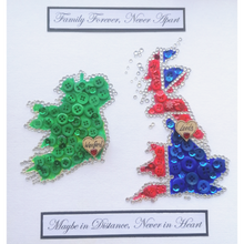 Load image into Gallery viewer, Two maps button design. Ireland and the UK are presented together in this 10 x10&quot; Irish made box frame. The maps are made up using tiny crystals, buttons and star embellishments.   Place names can be added to both maps written in wooden hearts. Personalised text can also be added to the top of the maps, the bottom or both. Please inform me of these details in the custom message box.
